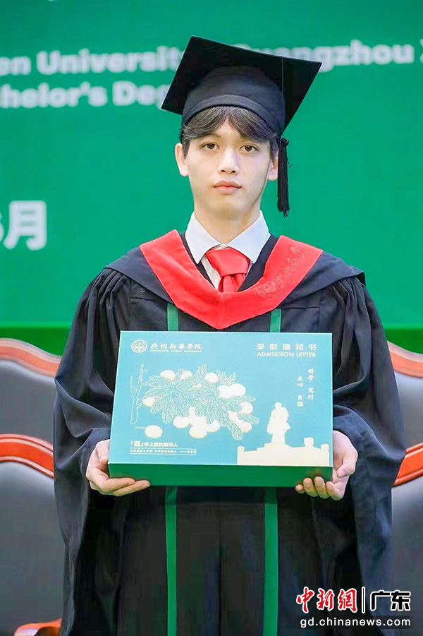 2023届毕业生手捧广州新华学院录取通知书盒子欢迎2023级新生(广州新华学院供图)